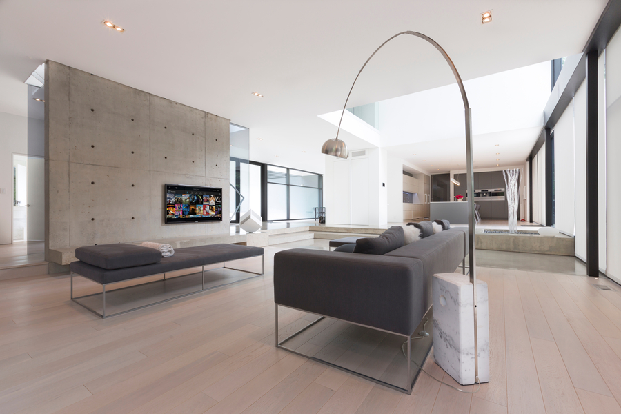 Luxury open-concept living room with a couch facing a wall-mounted TV